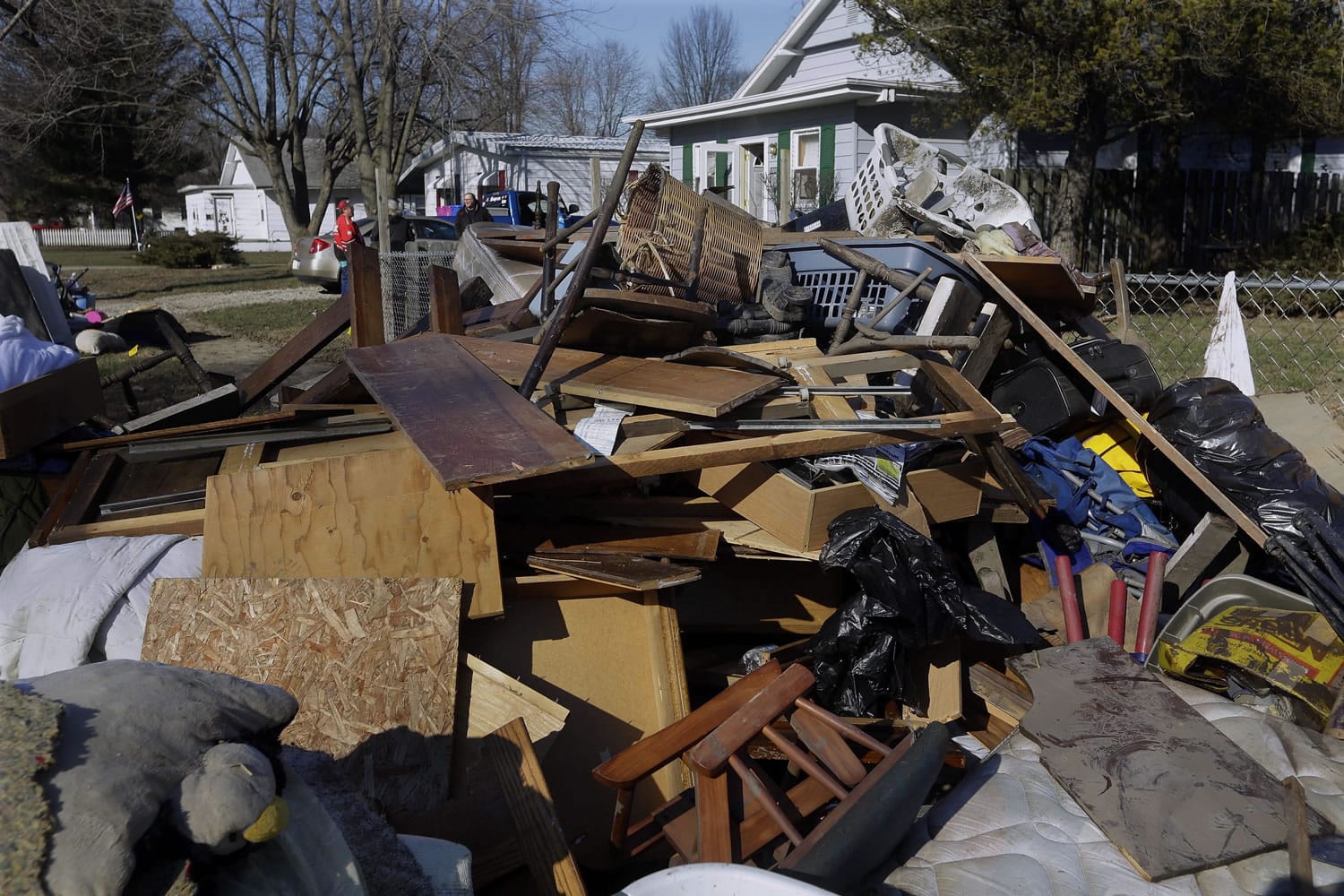 Residents pile ruined furniture, appliances and clothes along the street Sunday for disposal crews to pick up after last week&#039;s flooding from the south fork of the Sangamon River in Kincaid, Ill. Gov. Bruce Rauner toured flood-damaged homes there Sunday.