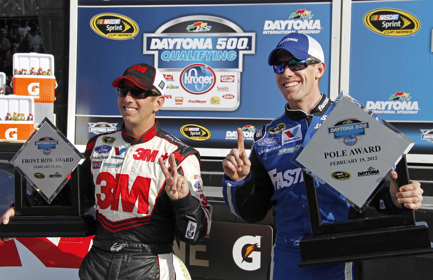 Greg Bifflle, left, of Vancouver, and Carl Edwards, right, hold up their trophies after securing the top two positions during qualifying for the NASCAR Daytona 500 on Sunday. Edwards won the pole for the Feb.