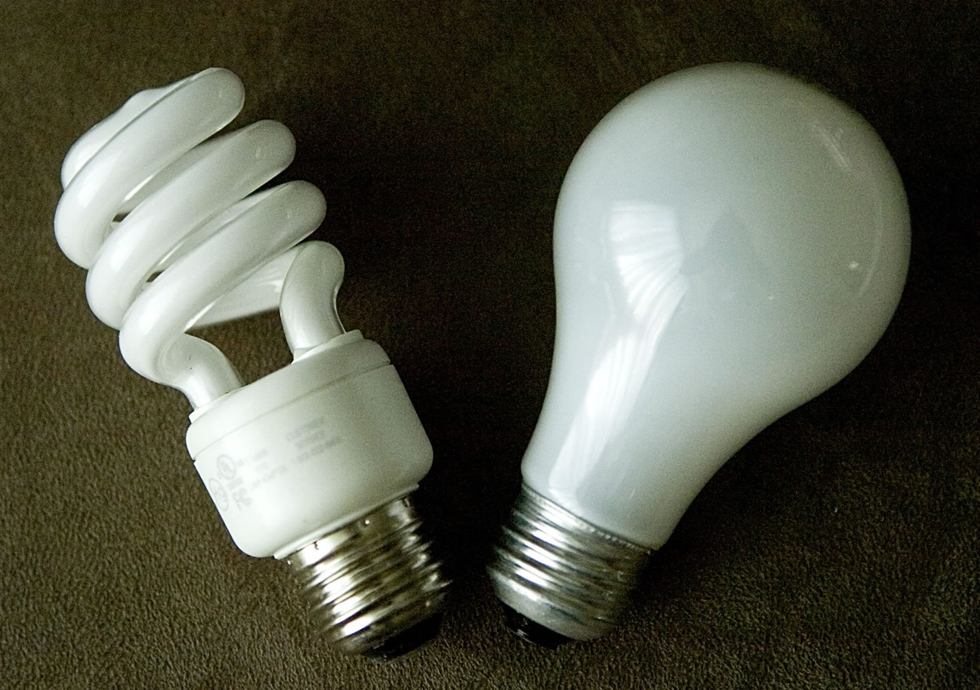 A traditional incandescent bulb, right, and a more energy-efficient compact fluorescent.