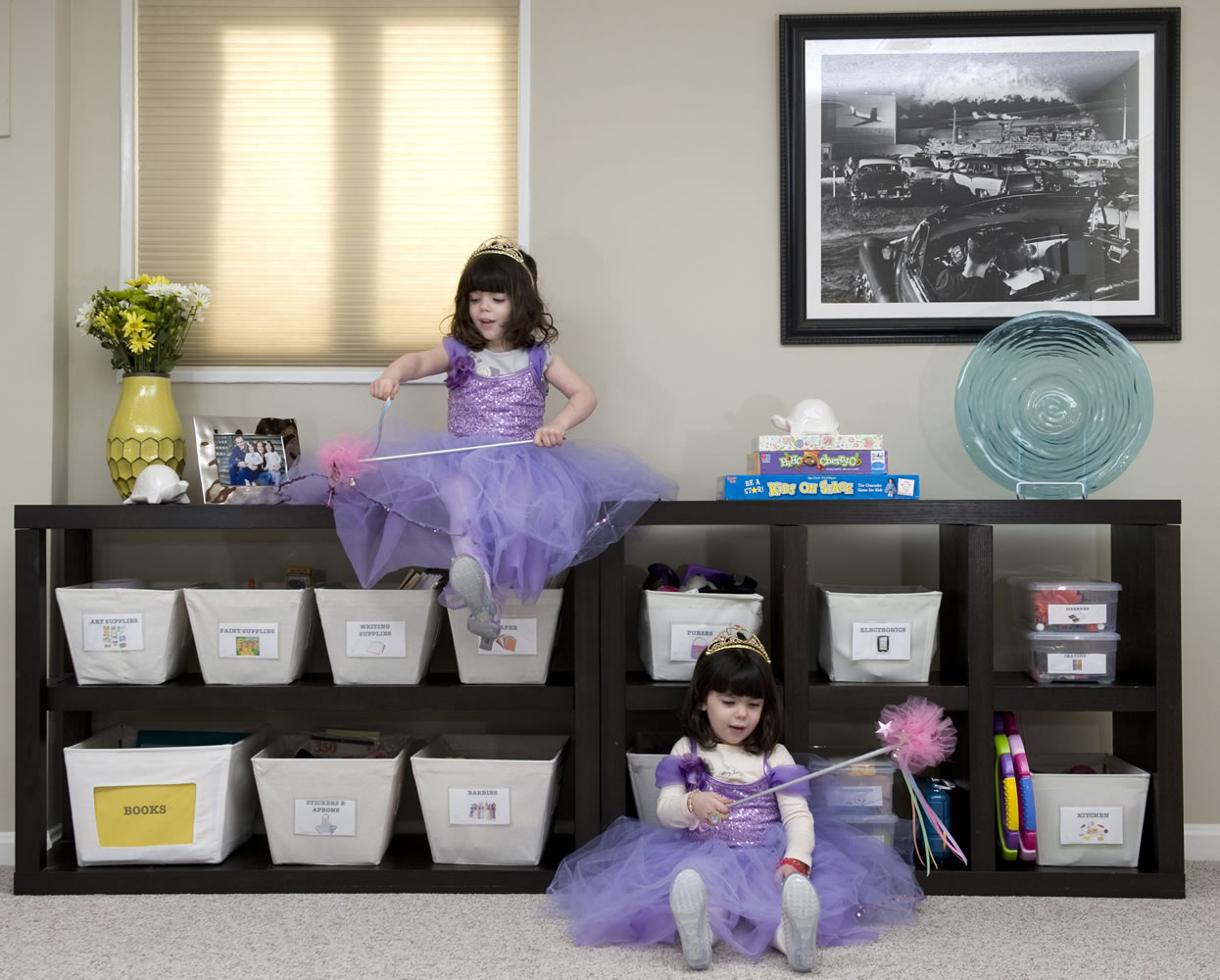 Professional organizer Rachel Strisik's 4-year-old twins Marin, left, and Ellie play dress-up in their playroom of their Bethesda, Md., home.