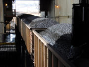 Coal is loaded onto hopper cars at the Spring Creek Mine near Decker, Mont., 2013. At least 30 applications from companies seeking to mine hundreds of millions of tons of coal face suspension as the government reviews its sales of the fuel from public lands, U.S. officials disclosed Friday.