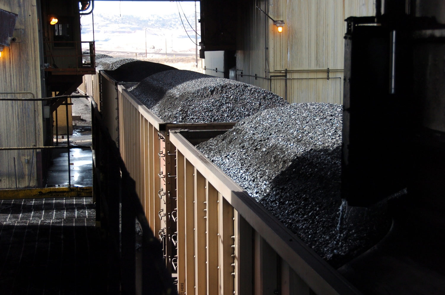 Coal is loaded onto hopper cars at the Spring Creek Mine near Decker, Mont., 2013. At least 30 applications from companies seeking to mine hundreds of millions of tons of coal face suspension as the government reviews its sales of the fuel from public lands, U.S. officials disclosed Friday.