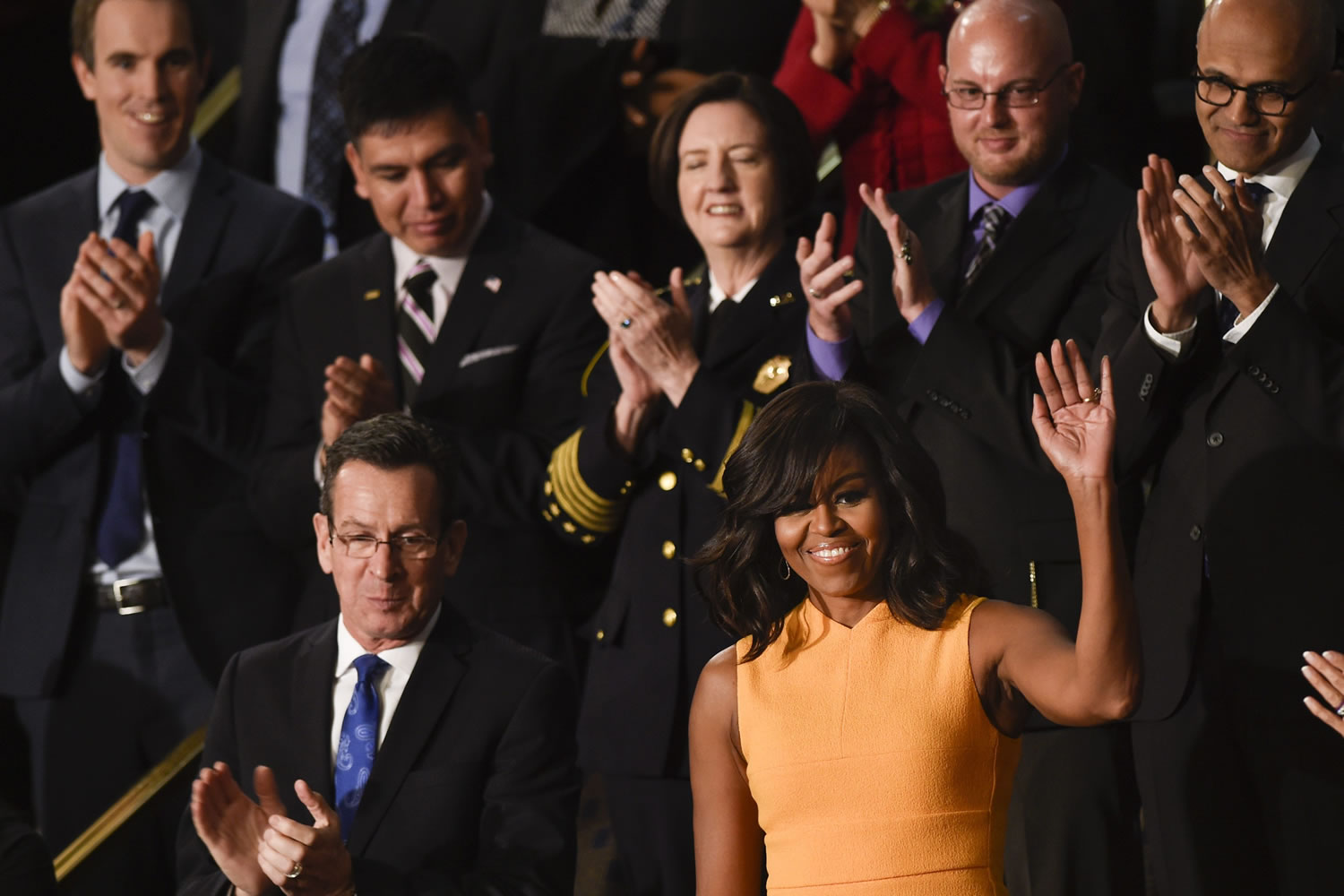 First lady Michelle Obama, standing next to Connecticut Gov. Dannel Malloy, waves on Capitol Hill in Washington on Tuesday prior to the start of President Barack Obama&#039;s State of the Union address before a joint session of Congress.