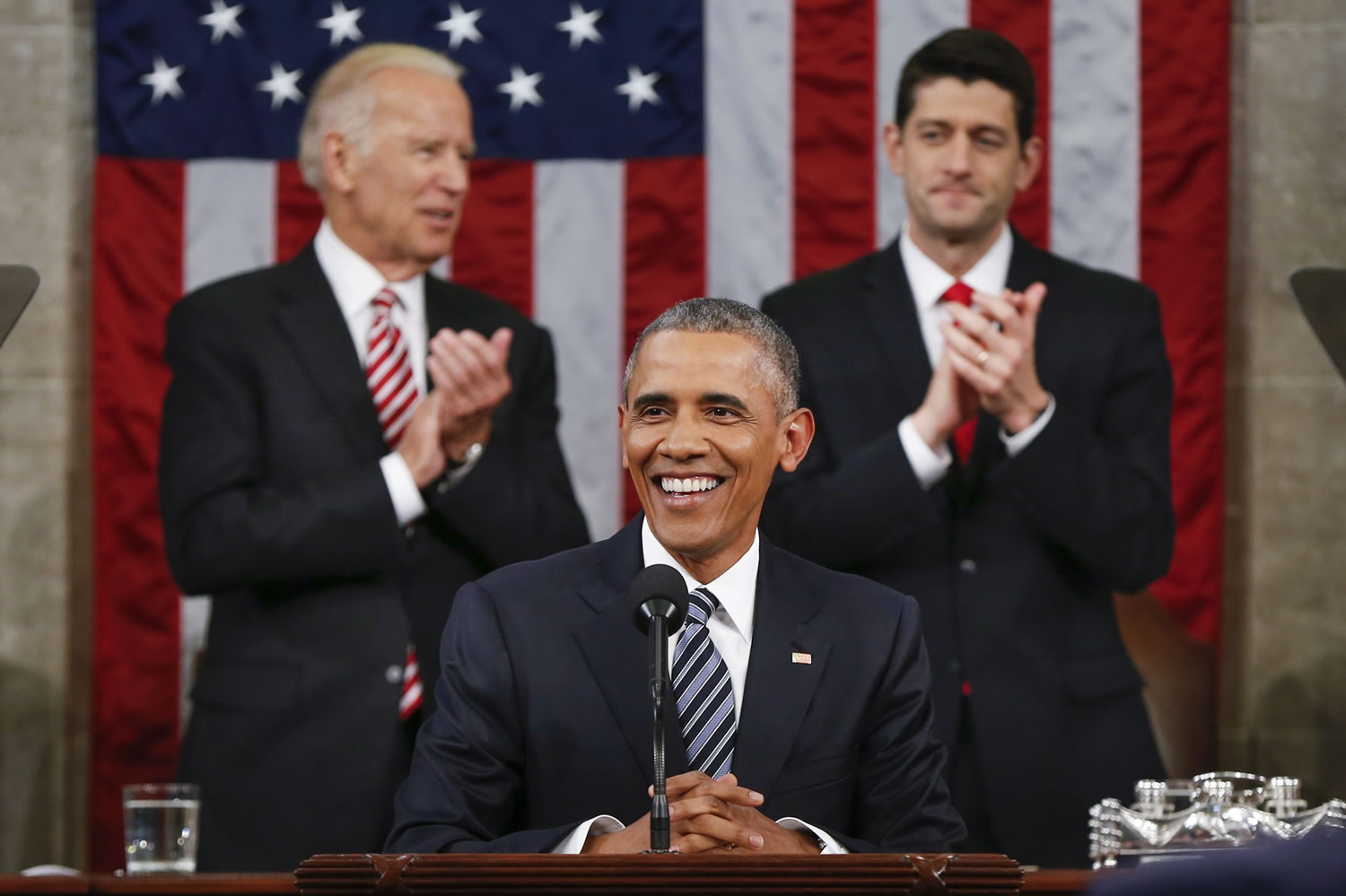 Vice President Joe Biden and Speaker Paul Ryan of Wisconsin applaud President Barack Obama on Tuesday during the State of the Union address before a joint session of Congress on Capitol Hill in Washington.