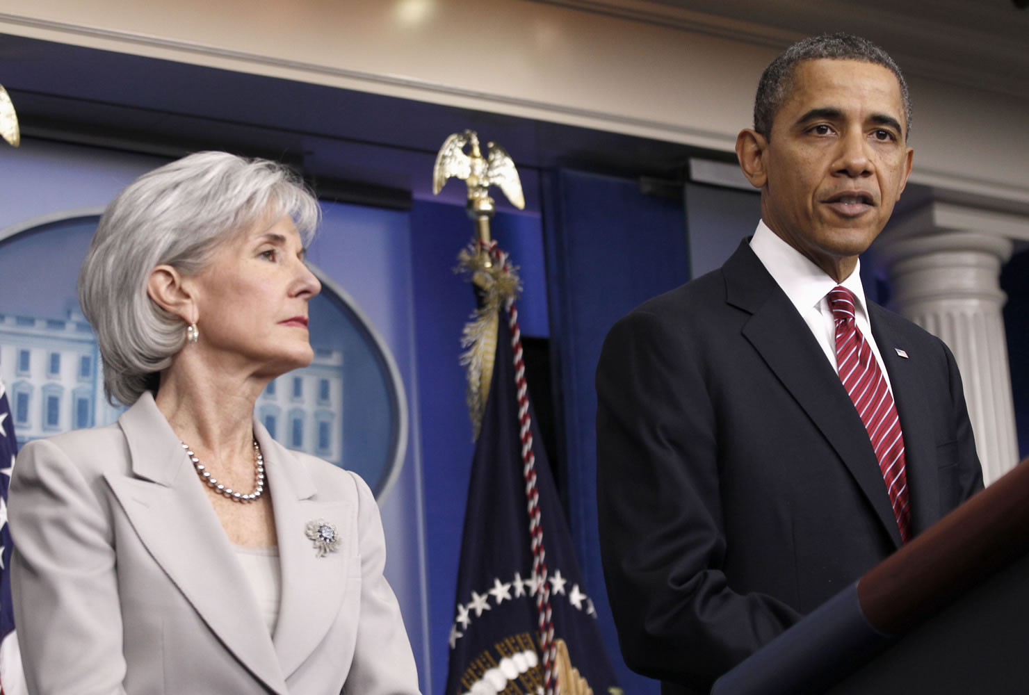 President Barack Obama, accompanied by Health and Human Services Secretary  Kathleen Sebelius announces the revamp of his contraception policy requiring religious institutions to fully pay for birth control, Friday, Feb. 10, 2012,  in the Brady Press Briefing Room of the White House in Washington.