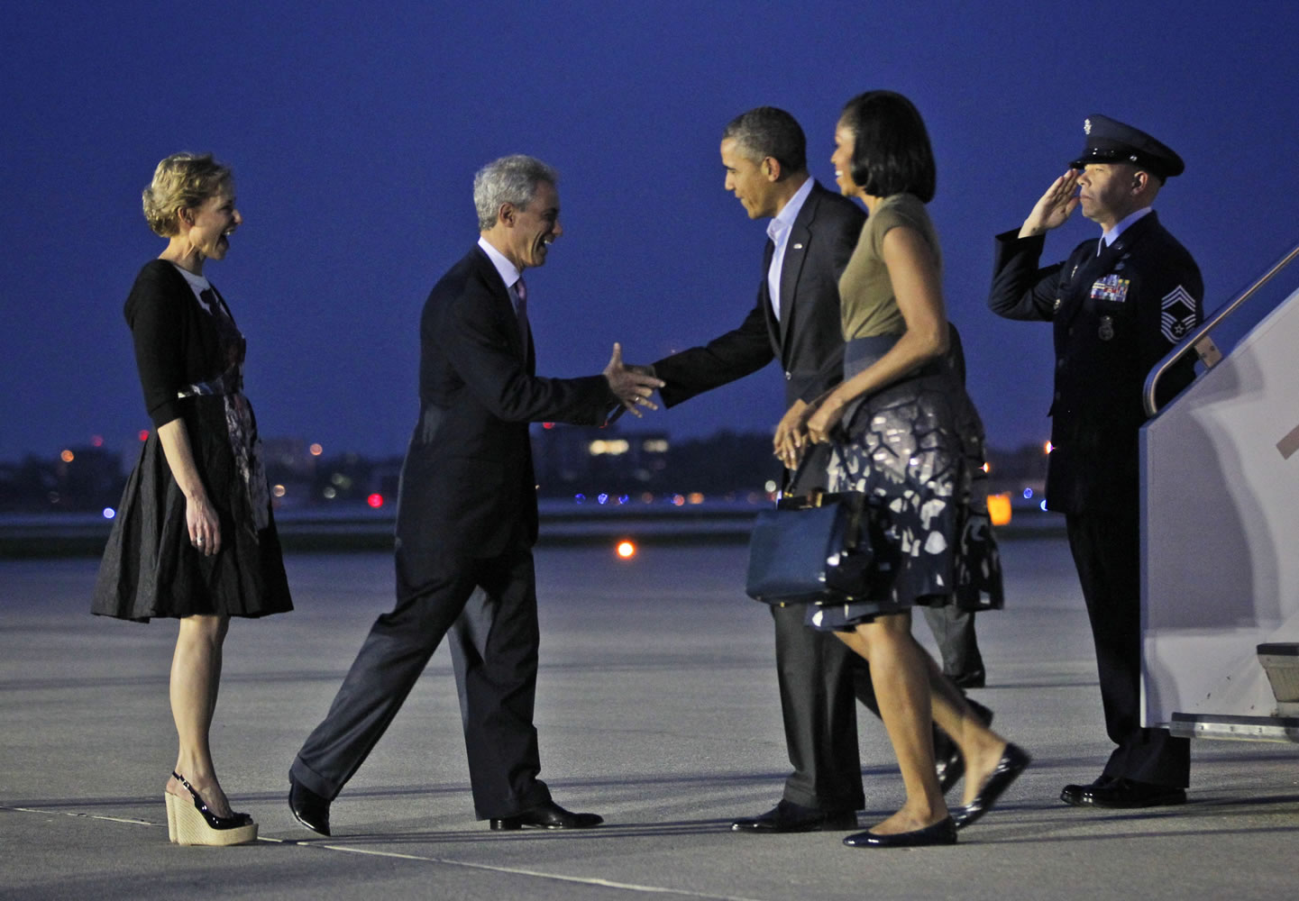 President Barack Obama and first lady Michelle Obama, right, are greeted Saturdayby Chicago Mayor Rahm Emanuel and his wife, Amy Rule, upon their arrival at O'Hare International Airport in Chicago.