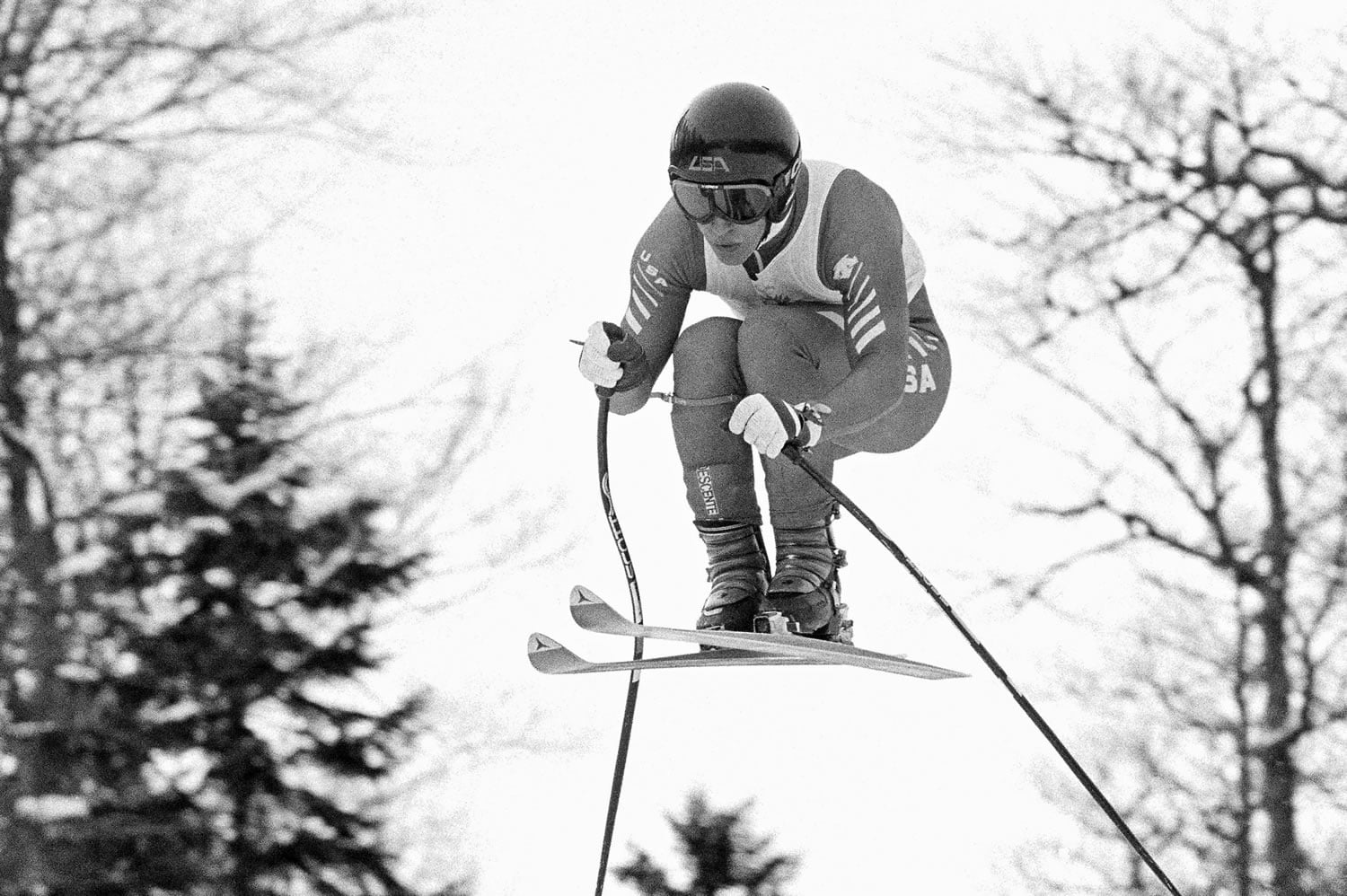 American Olympic downhill skier Bill Johnson races Feb. 6, 1984, during the third training run for the Winter Olympic alpine skiing events, near Sarajevo, Bosnia-Herzegovina. The U.S. ski team says the former Olympic downhill champion has died after a long illness. He was 55. Megan Harrod, a spokeswoman for the U.S. Alpine team, says Johnson died Thursday at an assisted living facility in Gresham, Ore.
