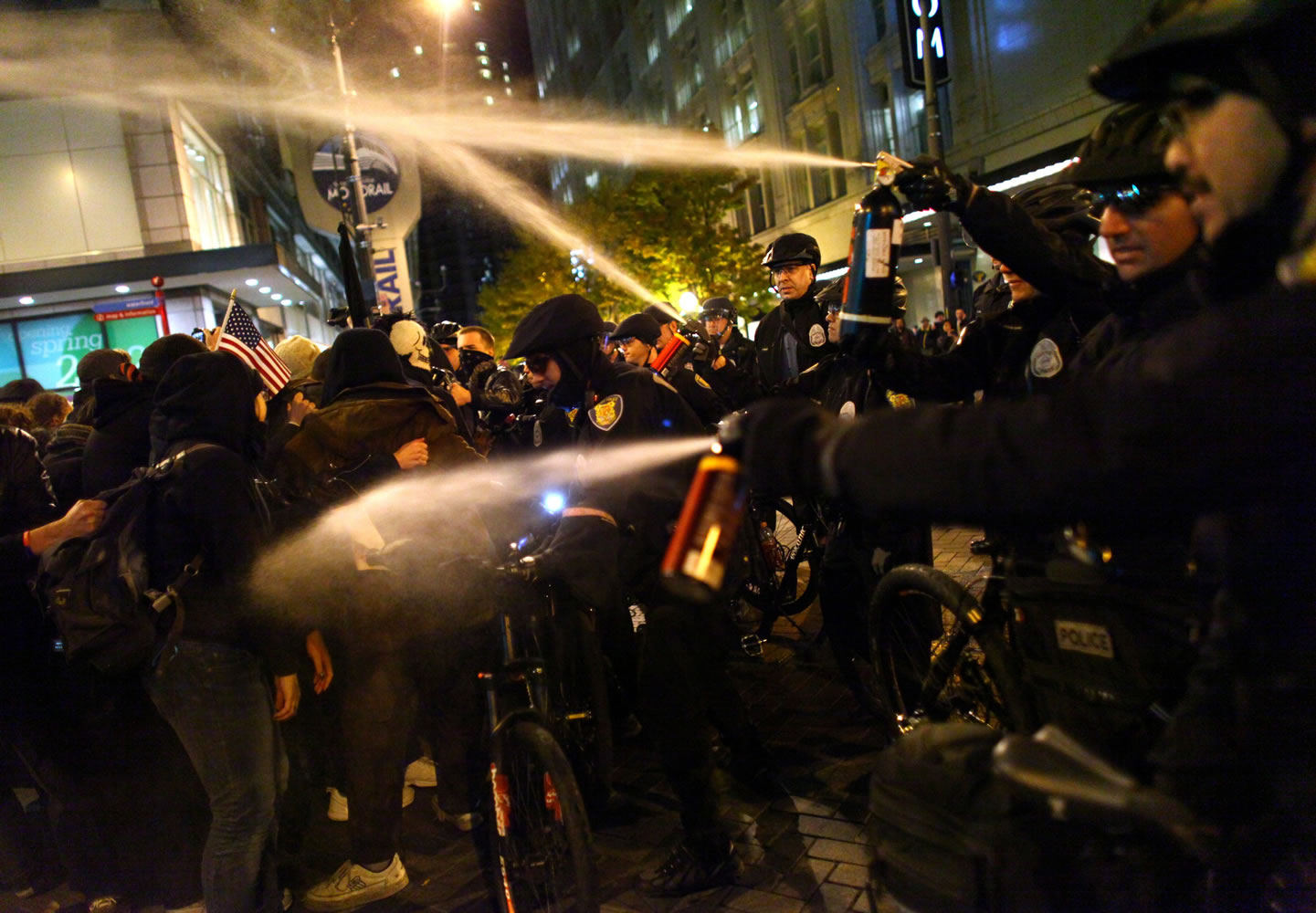 Seattle Police officers deploy pepper spray into a crowd during an Occupy Seattle protest on Tuesday at Westlake Park in Seattle.