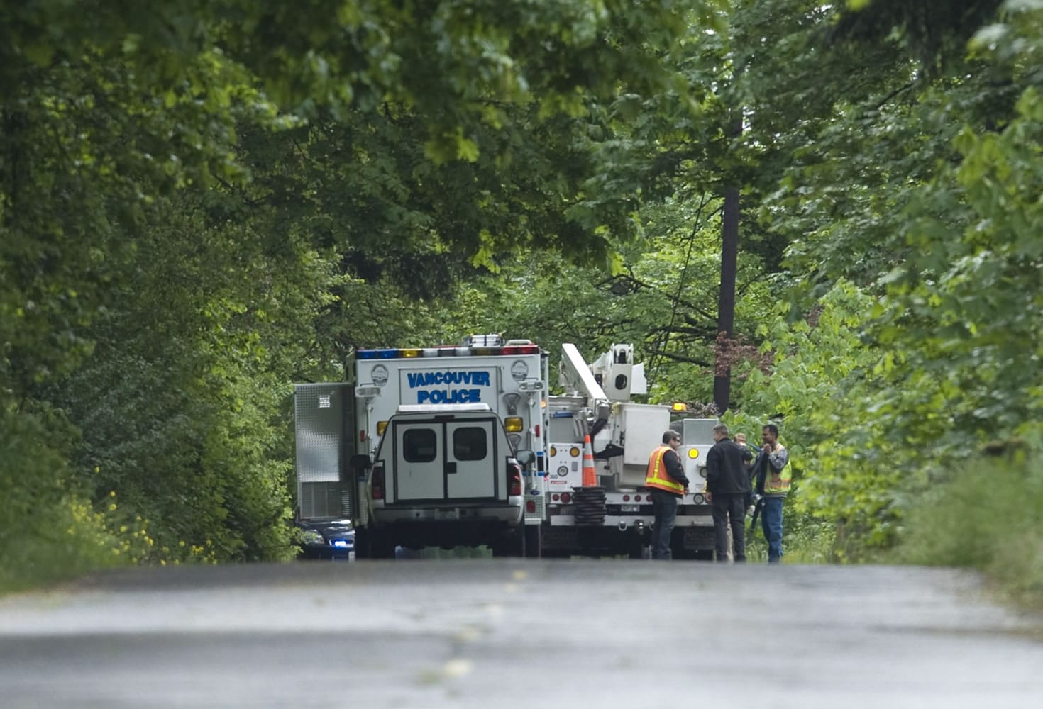 Vancouver police investigate the scene along the old Evergreen Highway where a woman's body was recovered early Thursday.