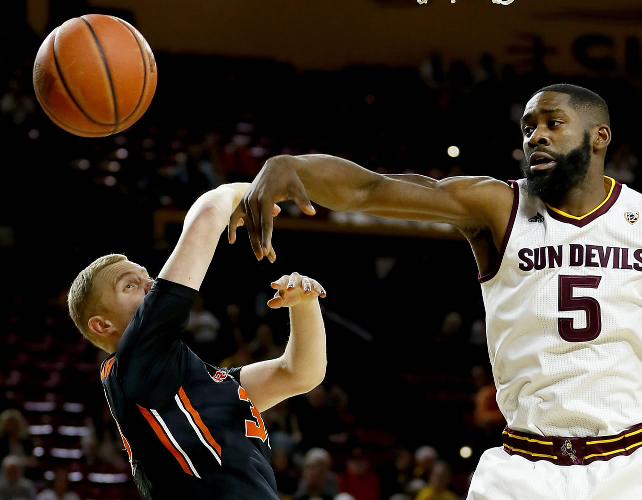 Arizona State's Obinna Oleka (5) knocks the ball away from Oregon State's Olaf Schaftenaar during the first half of an NCAA college basketball game, Thursday, Jan. 28, 2016, in Tempe, Ariz.