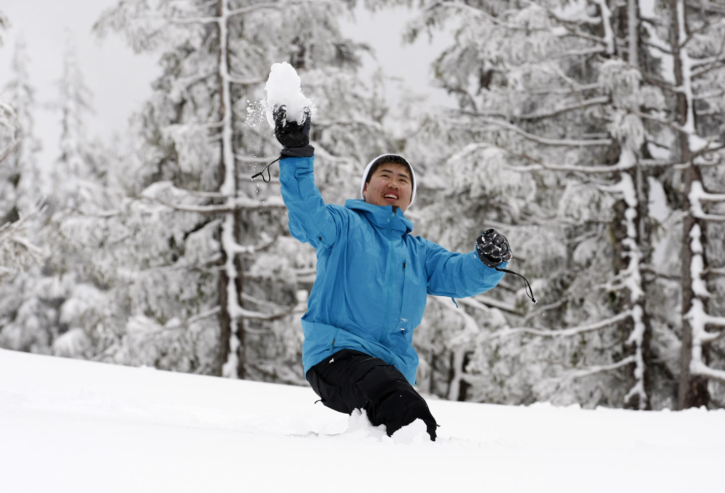 Kevin Nguyen of Vancouver throws a snowball at his father Saturday at Timberline, Ore.