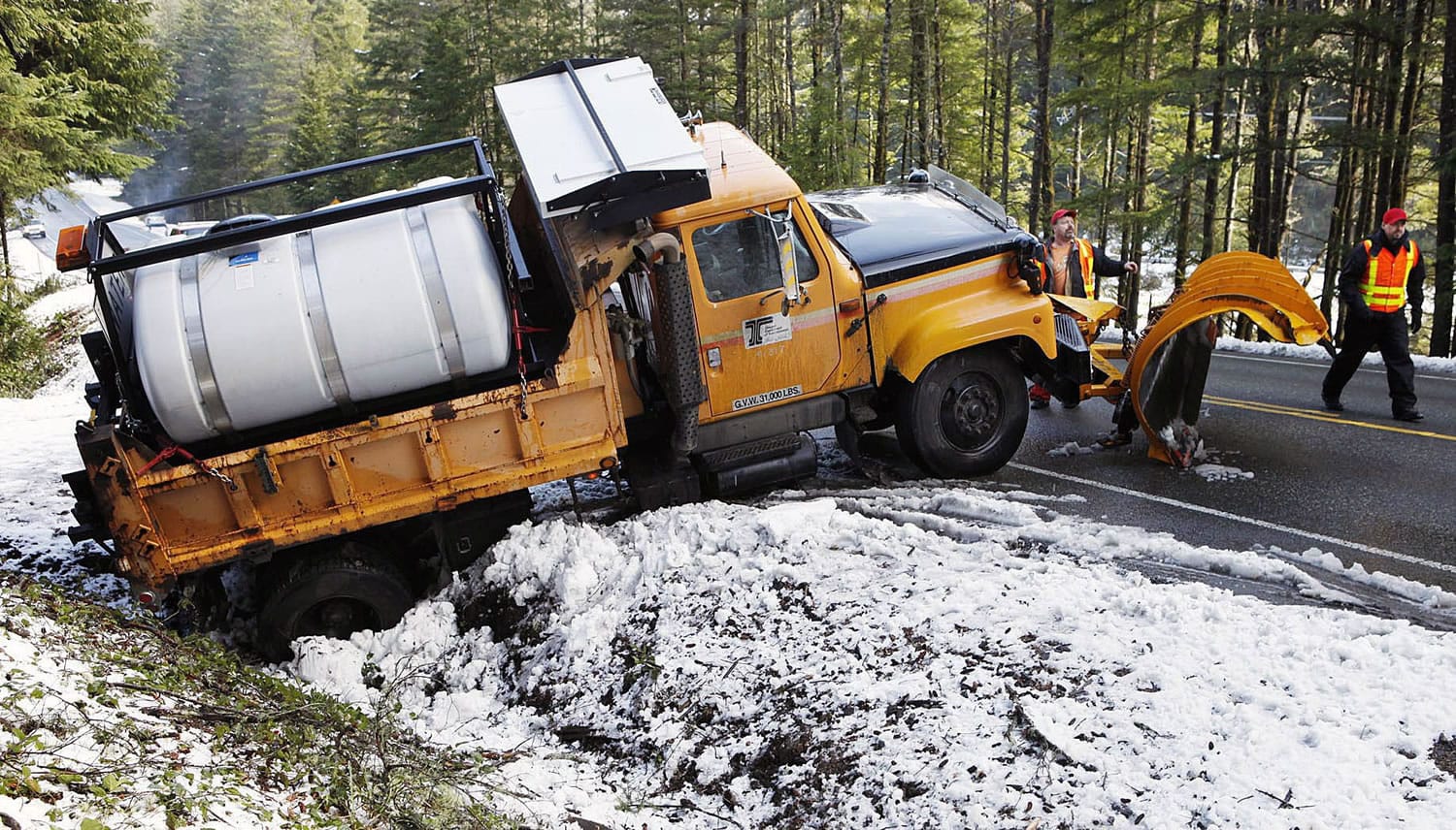 An Oregon Department of Transportation snow plow got stuck in a ditch on U.S. Highway 101 in Coos County, Ore., on Tuesday.
