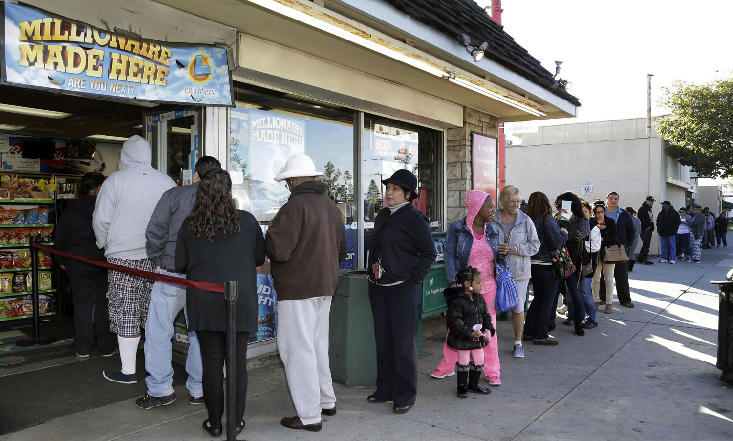 Customers wait in line to buy Powerball tickets Friday at the Blue Bird Liquor Store in Hawthorne, Calif.