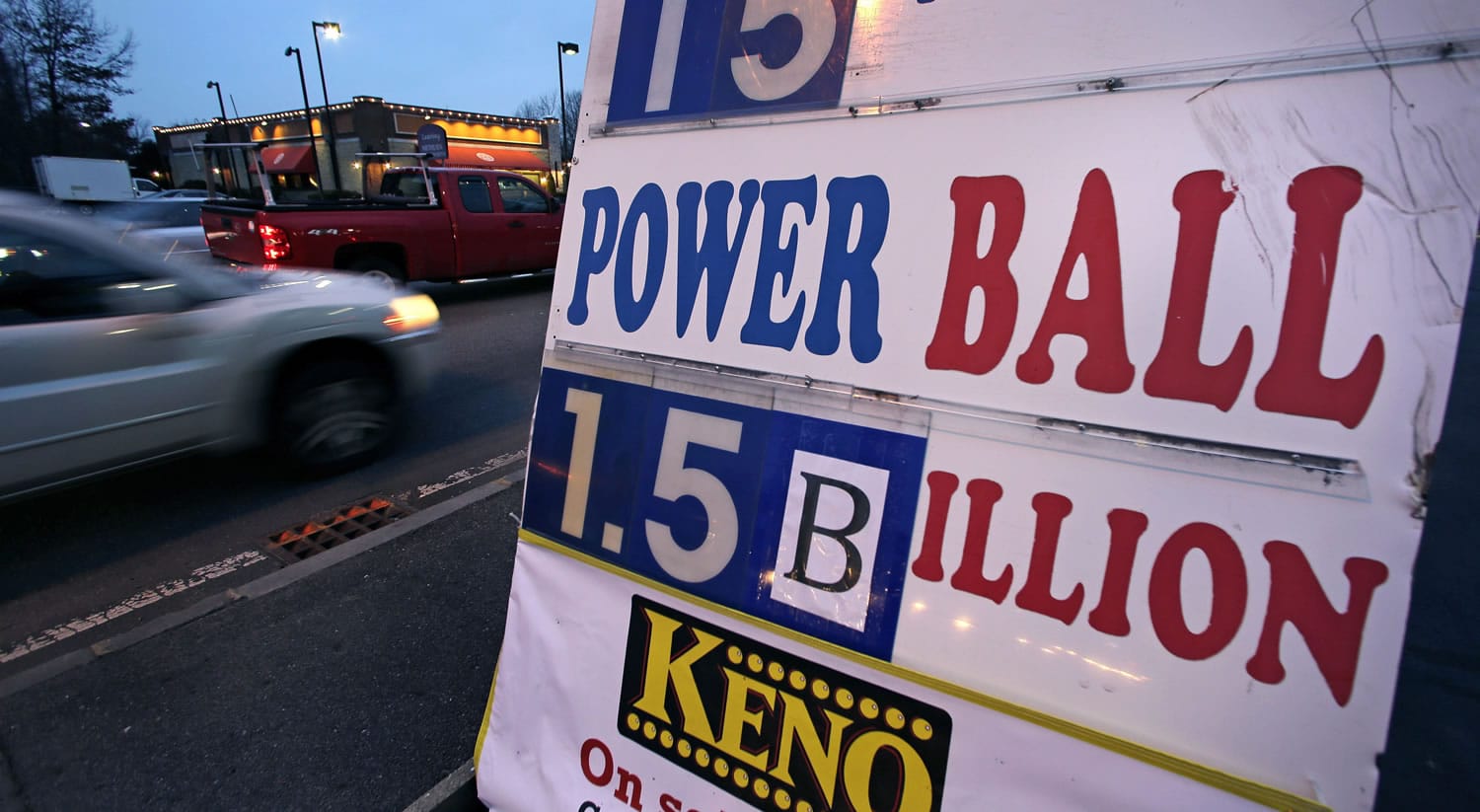 Commuters drive past a sign showing the Powerball jackpot in Wednesday&#039;s drawing is posted outside the Mobil Mart in Methuen, Mass., Tuesday, Jan. 12, 2016.