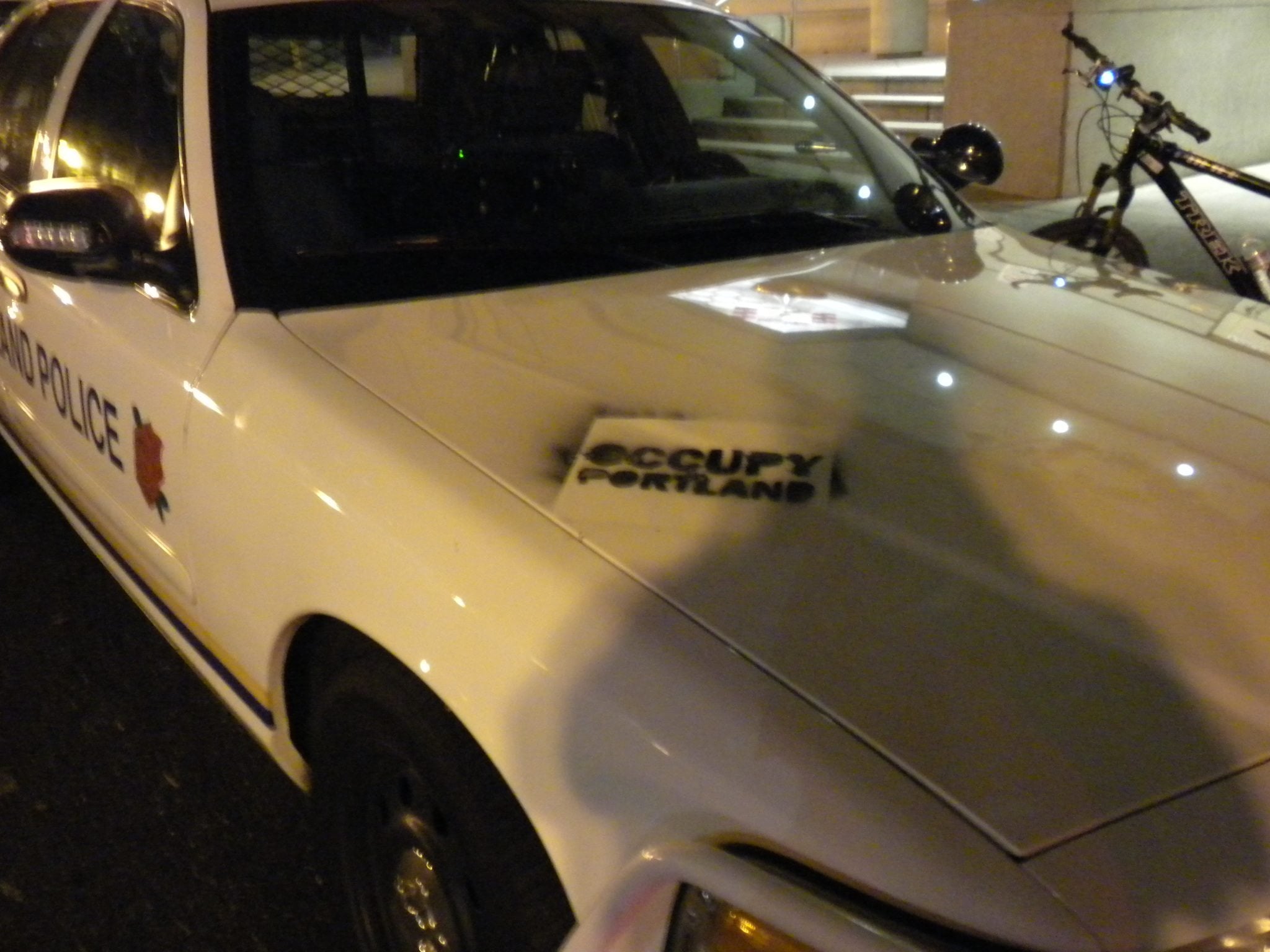 Police arrested two men overnight for allegedly tagging a Portland Police Bureau car, the Pioneer Square Starbucks and several other locations downtown.