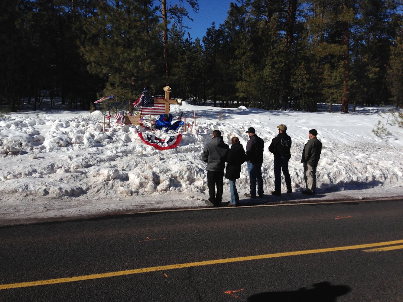 Mourners gather Sunday on U.S. Highway 395 at a roadside memorial where rancher LaVoy Finicum was shot and killed Tuesday night in a confrontation with the FBI and Oregon State Police near Burns, Ore. (Nick K.