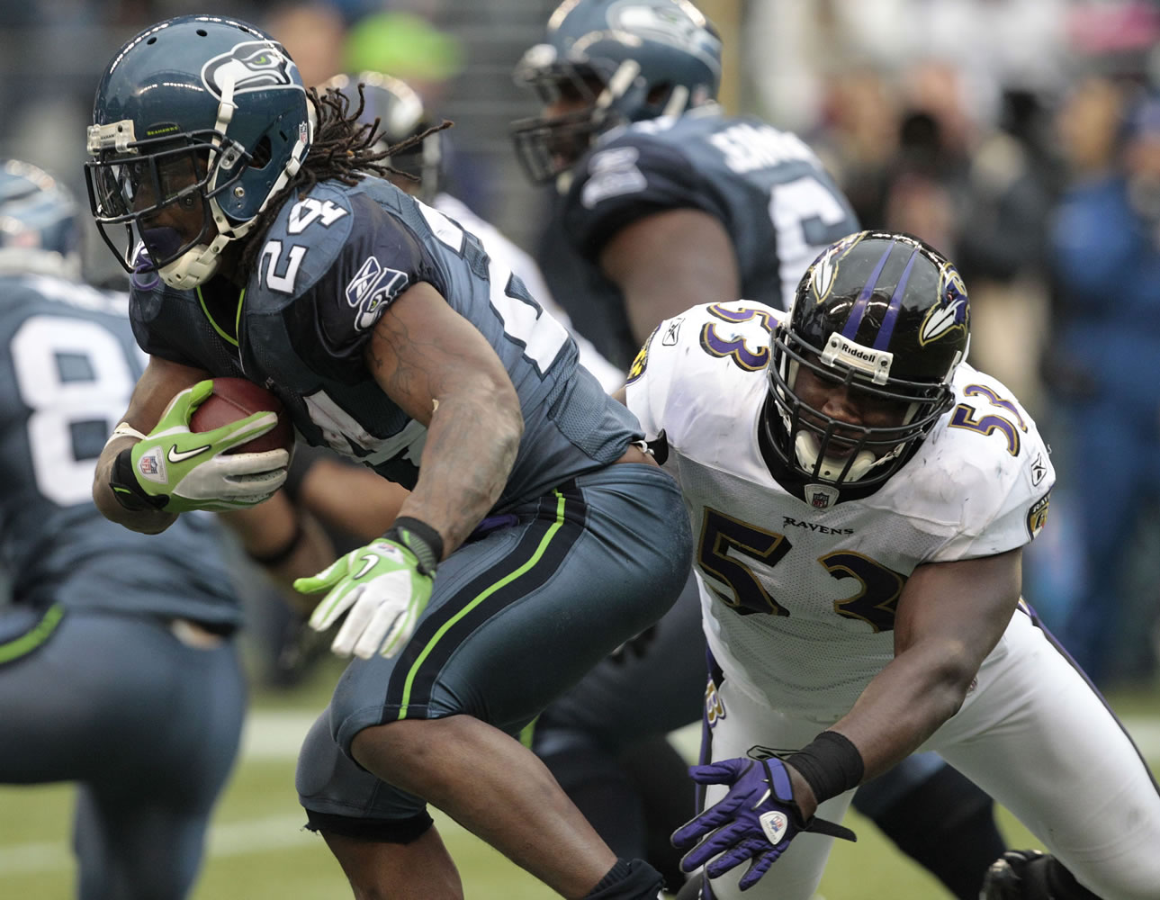 Marshawn Lynch (24) evades Baltimore's Jameel McClain in the second half Sunday.