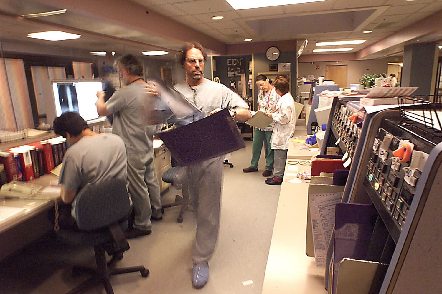 Dr. Marty Bell carries a set of patient X-rays in the emergency room of then-Southwest Washington Medical Center in 2000. Bell is director of emergency services at the now PeaceHealth Southwest Medical Center.