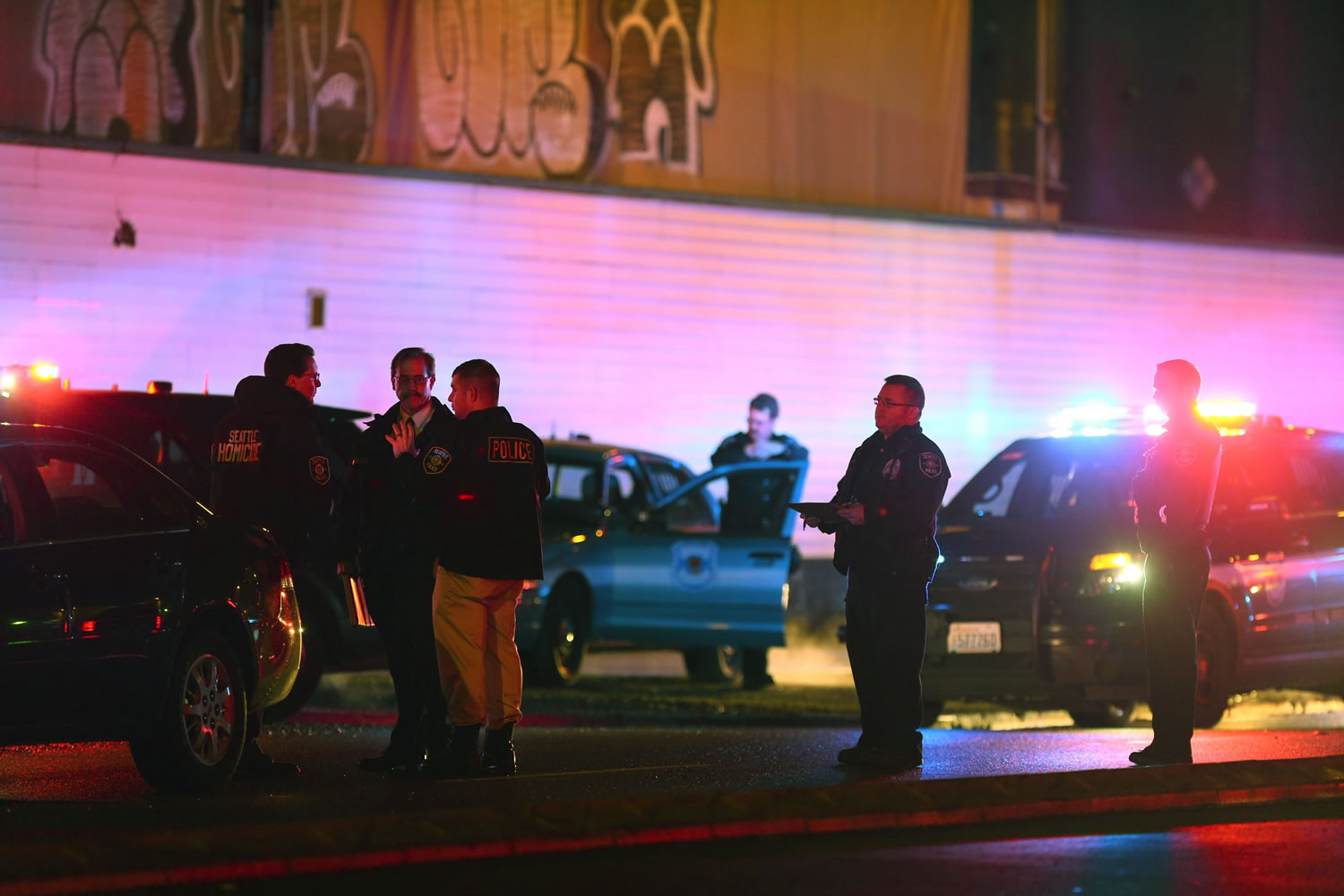 Law enforcement and medics respond to a shooting near Airport Way South and Atlantic Street on Tuesday, Jan. 26, 2015 in Seattle. Police say two people have been fatally shot and three others wounded by gunfire at a homeless encampment.