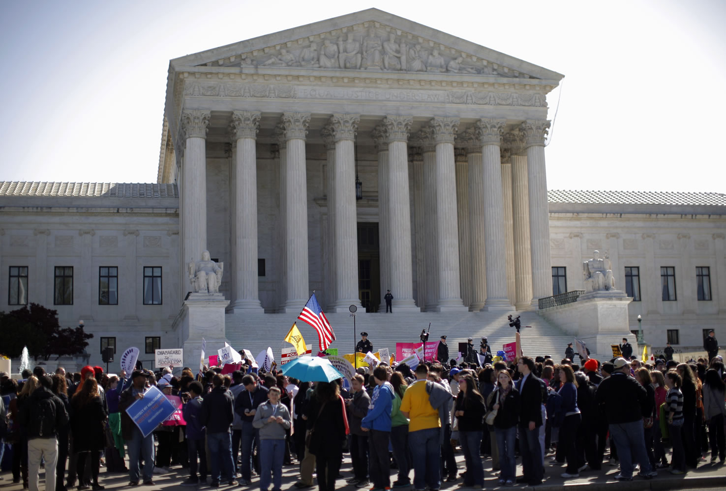 Supporters and opponents of health care reform rally in front of the Supreme Court in Washington on Tuesday as the court continued arguments on the health care law signed by President Barack Obama.