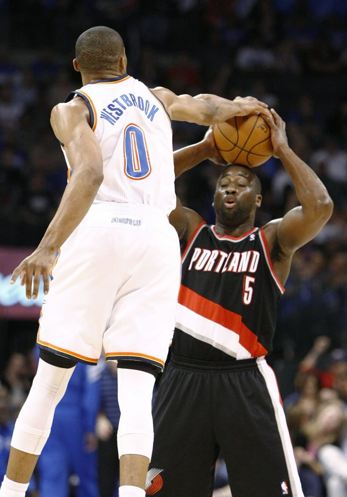 Oklahoma City Thunder guard Russell Westbrook (0) blocks a shot by the Portland Trail Blazers' Raymond Felton (5) during the first half the Thunder's win over Portland, who ended a seven-game road trip.