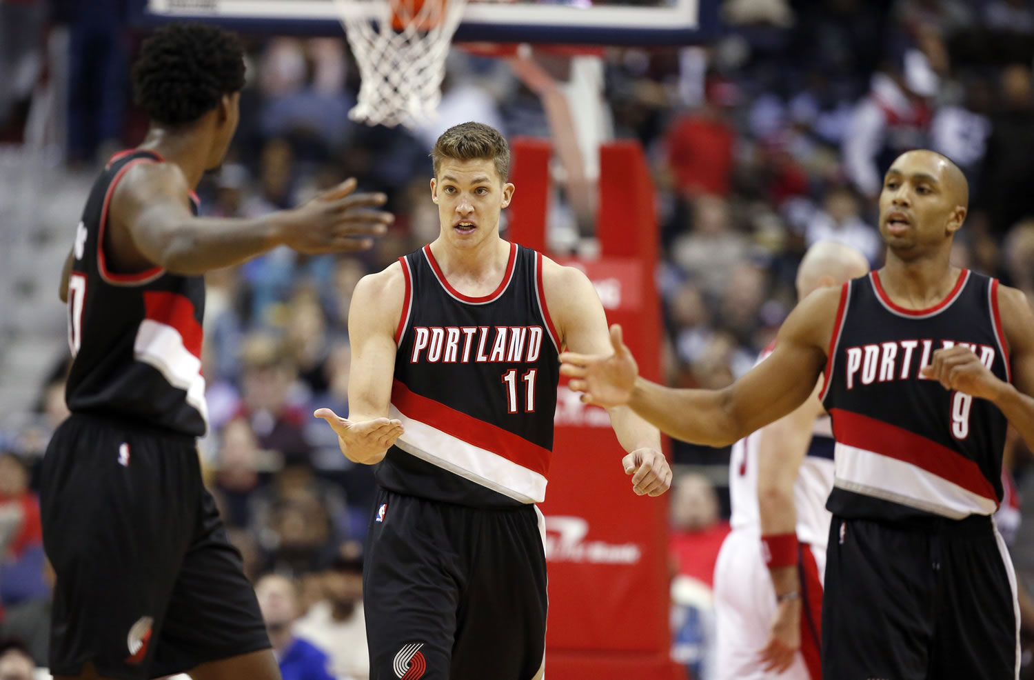 Portland Trail Blazers center Ed Davis, left, forward Meyers Leonard (11) and guard Gerald Henderson (9) celebrate in the second half of an NBA basketball game against the Washington Wizards, Monday, Jan. 18, 2016, in Washington. The Trail Blazers won 108-98.
