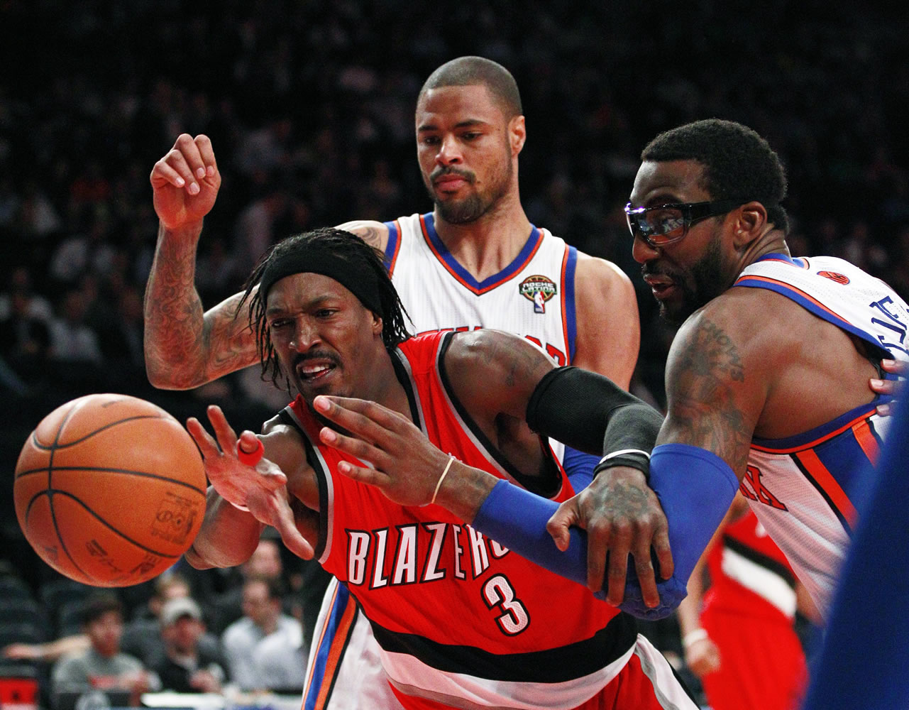 Portland Trail Blazers' Gerald Wallace (3) is defended by New York Knicks' Amare Stoudemire, right, and Tyson Chandler, above, during the second half of an NBA basketball game Wednesday, March 14, 2012, in New York.