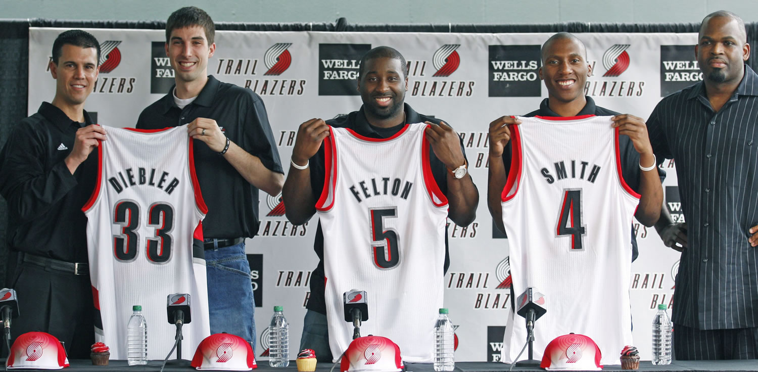 Portland Trail Blazers' acting general manager Chad Buchanan; Jon Diebler; Raymond Felton; Nolan Smith and head coach Nate McMillan pose for a photo during a news conference Monday introducing the newest Trail Blazers.