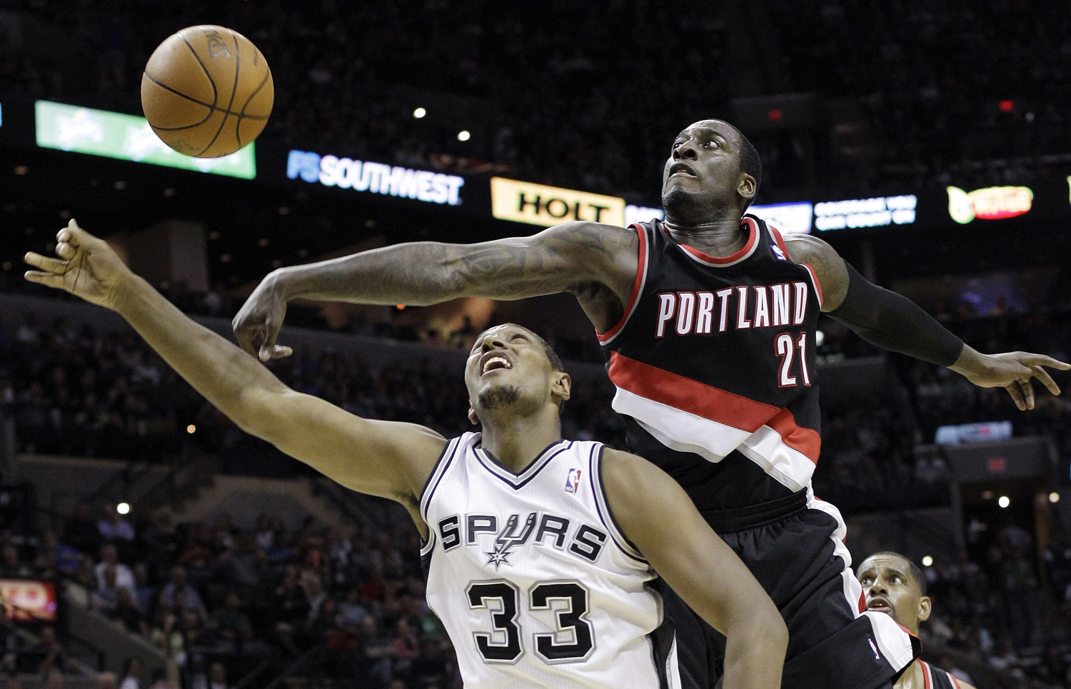 San Antonio Spurs' Boris Diaw (33) has his shot blocked by Portland Trail Blazers' J.J.
