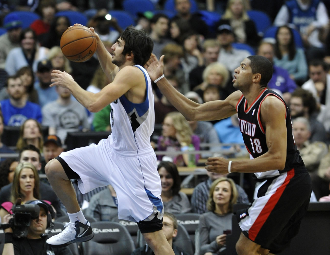 Minnesota Timberwolves' Ricky Rubio, left, of Spain, lays up ahead of Portland Trail Blazers' Nicolas Batum, of France, during the second half of an NBA basketball game Wednesday, March 7, 2012 in Minneapolis. The Timberwolves won 106-94.