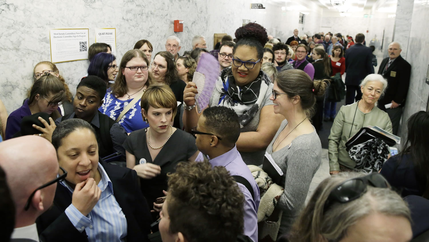 People pack a hallway outside a Washington Senate hearing room,  Jan. 27 at the Capitol in Olympia, as they wait to listen to public testimony regarding a bill that would eliminate Washington's new rule allowing transgender people use gender-segregated bathrooms and locker rooms in public buildings consistent with their gender identity. (AP Photo/Ted S.