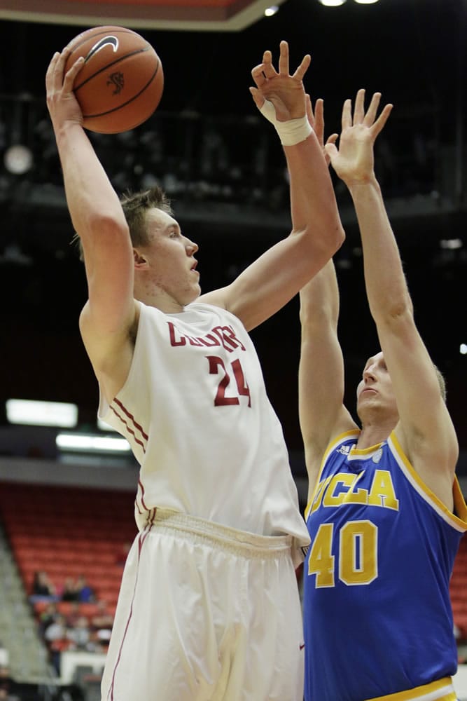 Washington State's Josh Hawkinson (24) shoots against UCLA's Thomas Welsh (40) during the first half of an NCAA college basketball game, Sunday, Jan. 3, 2016, in Pullman, Wash.