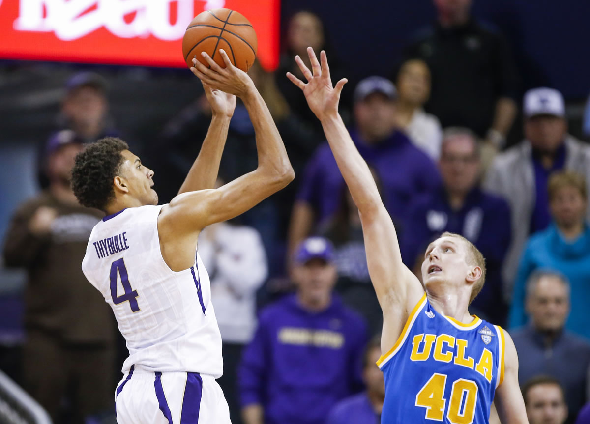 Washington forward Matisse Thybulle (4) shoots against UCLA center Thomas Welsh (40) during the first overtime of an NCAA college basketball game Friday, Jan. 1, 2016, in Seattle.