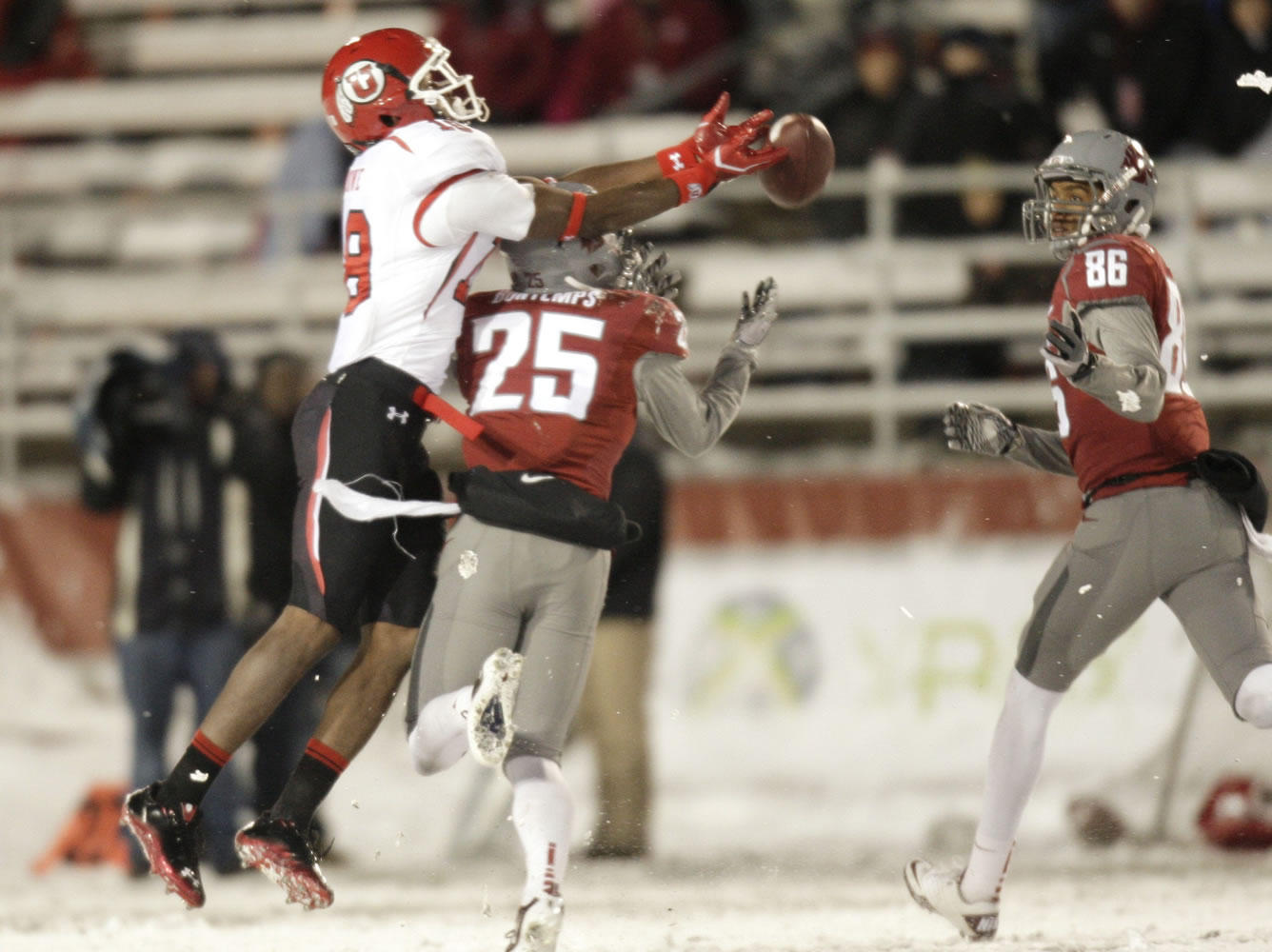 Utah defensive back Eric Rowe breaks up a pass intended for Washington State's Bennett Bontemps (25) during a snowy second half in Pullman on Saturday.