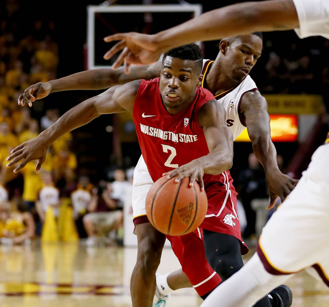 Washington State guard Ike Iroegbu (2) drives past Arizona State guard Gerry Blakes during the first half of an NCAA college basketball game Thursday, Jan. 14, 2016, in Tempe, Ariz.