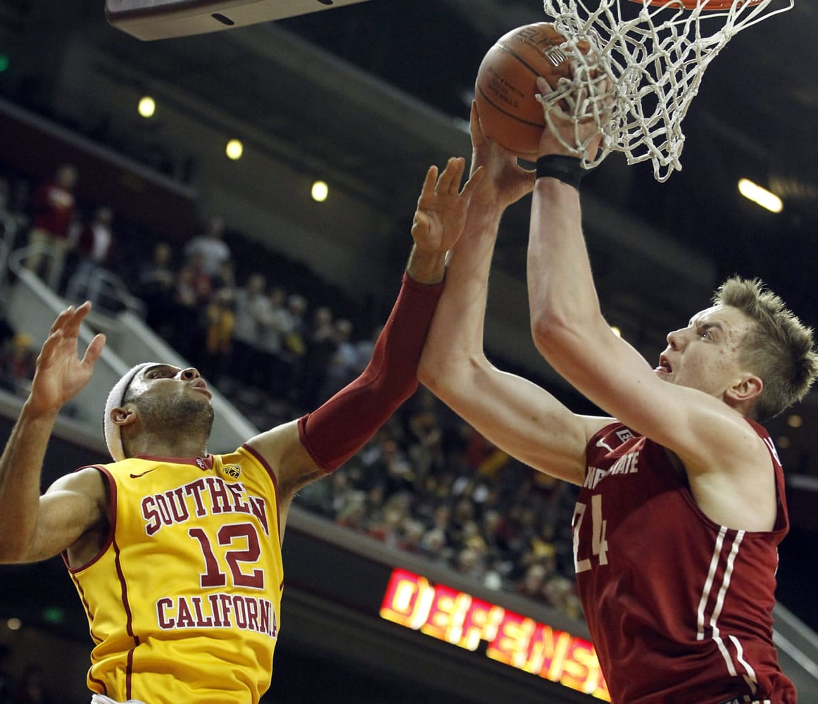 Washington State forward Josh Hawkinson, right, battles Southern California guard Julian Jacobs (12) for a rebound during the first half of an NCAA college basketball game in Los Angeles, Thursday, Jan. 28, 2016.