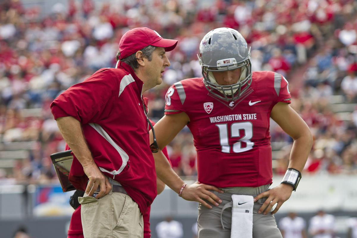 Washington State head coach Mike Leach gives instructions to backup quarterback Cody Clements during the Crimson and Gray game in Spokane on Saturday.