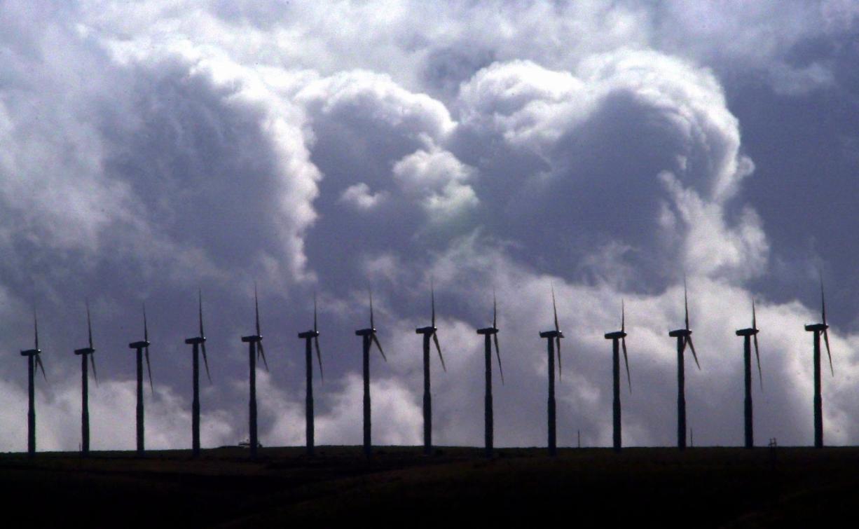 Wind turbines spin  under wind swept, cloudy skies along a ridge line in the Columbia River Gorge at FPL Energy's Stateline Wind Project on the Oregon-Washington border near Touchet, Wash., March 6, 2003.