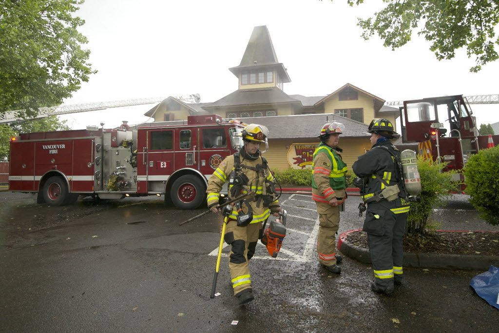 Vancouver firefighters work to contain a fire that broke out at Who Song &amp; Larry's restaurant Monday.
