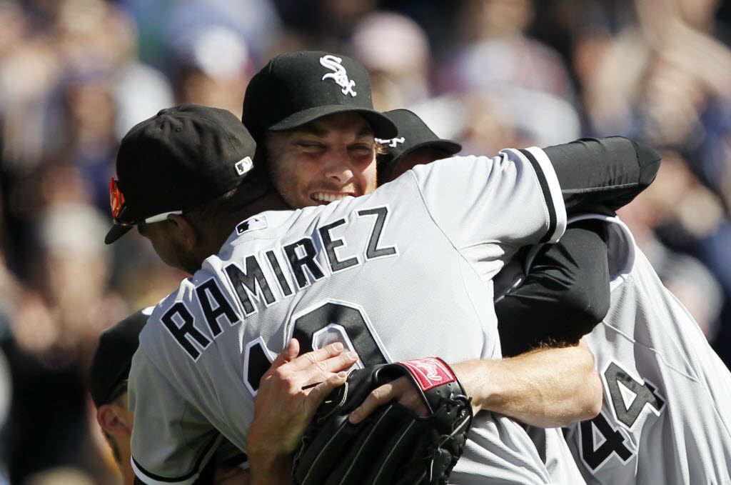 Chicago White Sox starting pitcher Philip Humber, center, is mobbed by teammates after pitching a perfect baseball game against the Seattle Mariners on Saturday at Safeco Field.