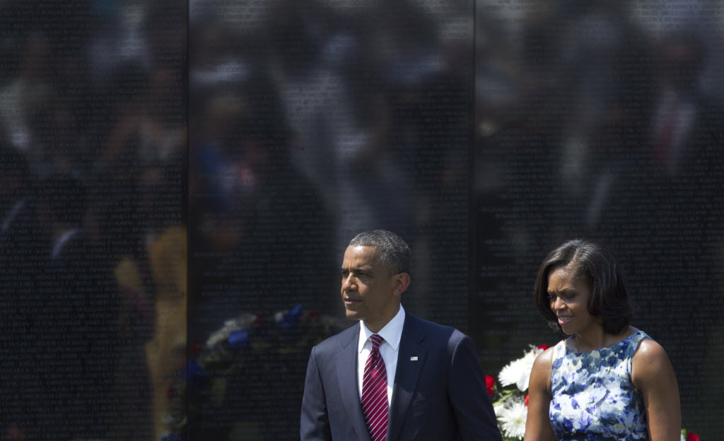 President Barack Obama and first lady Michelle Obama walk together during a Memorial Day ceremony at the Vietnam Veterans Memorial Wall to commemorate the 50th anniversary of the Vietnam War, Monday, in Washington, D.C.