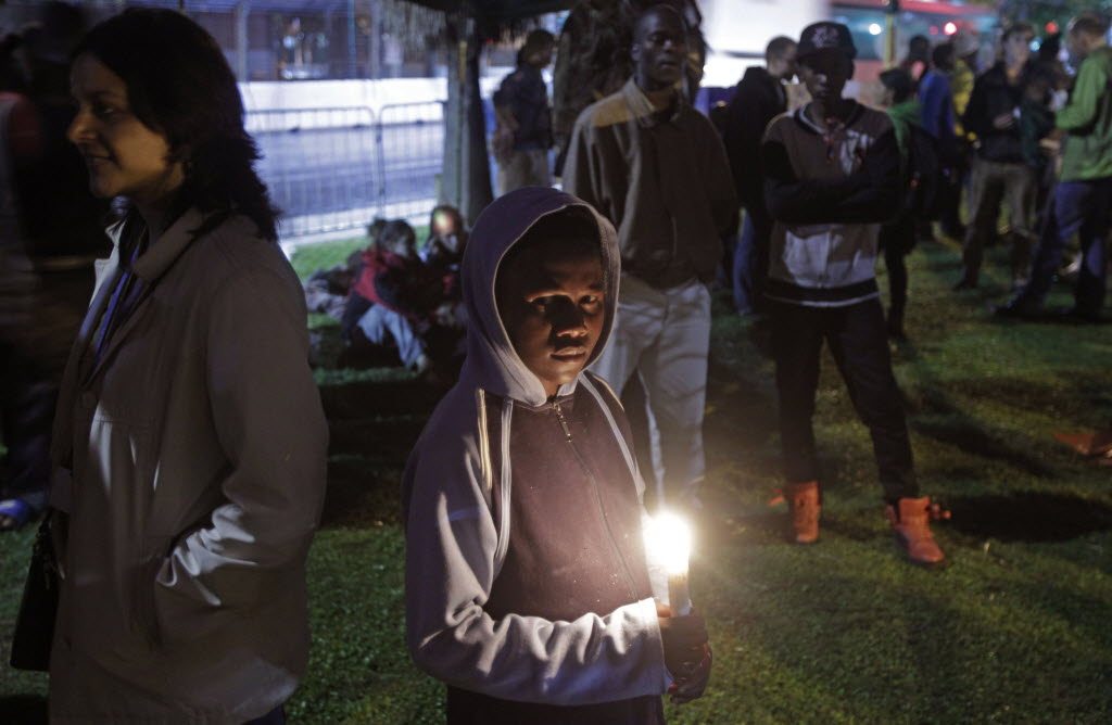 Protesters hold a night vigil as talks at the climate change summit stall in Durban, South Africa.