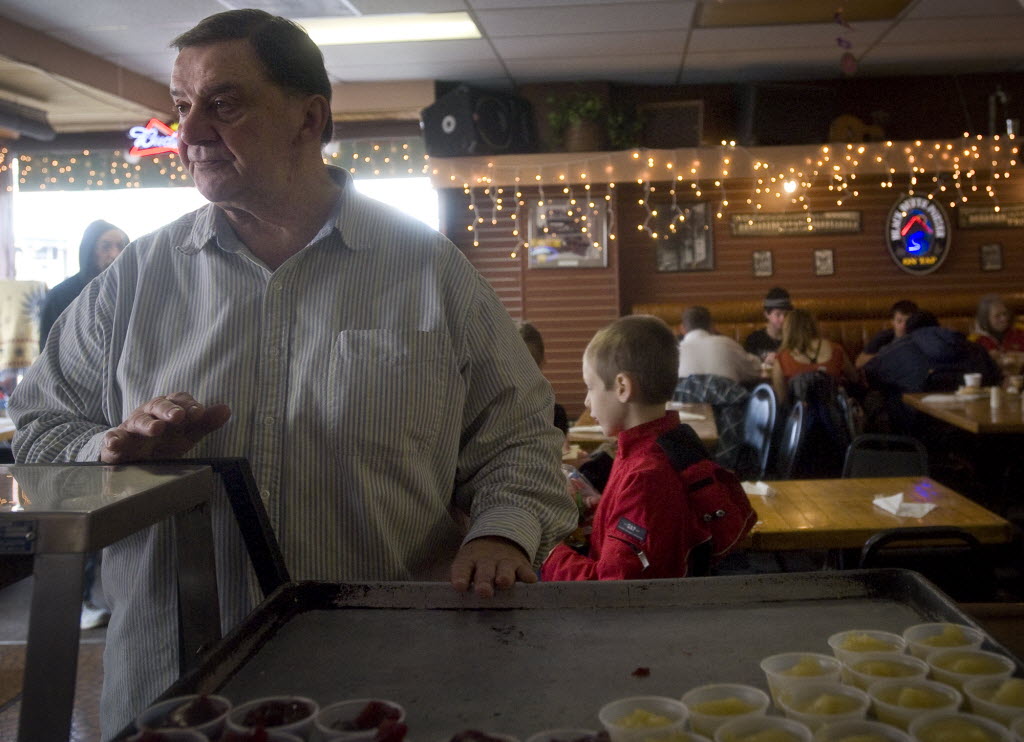 Bar Owner Chuck Chronis makes sure that all is going smoothly while he serves up a free Thanksgiving meal to those who need it at Chronis' Restaurant &amp; Lounge on November 25, 2010.