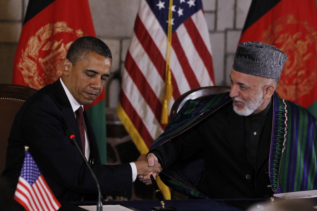 President Barack Obama, left, and Afghan President Hamid Karzai shake hands prior to signing a strategic partnership agreement at the presidential palace in Kabul, Afghanistan, on Wednesday.