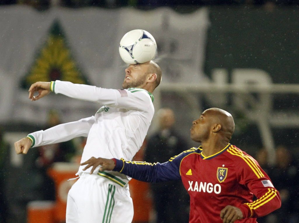 Portland Timbers forward Kris Boyd, left, heads the ball against Real Salt Lake defender Jamison Olave during the second half Saturday.