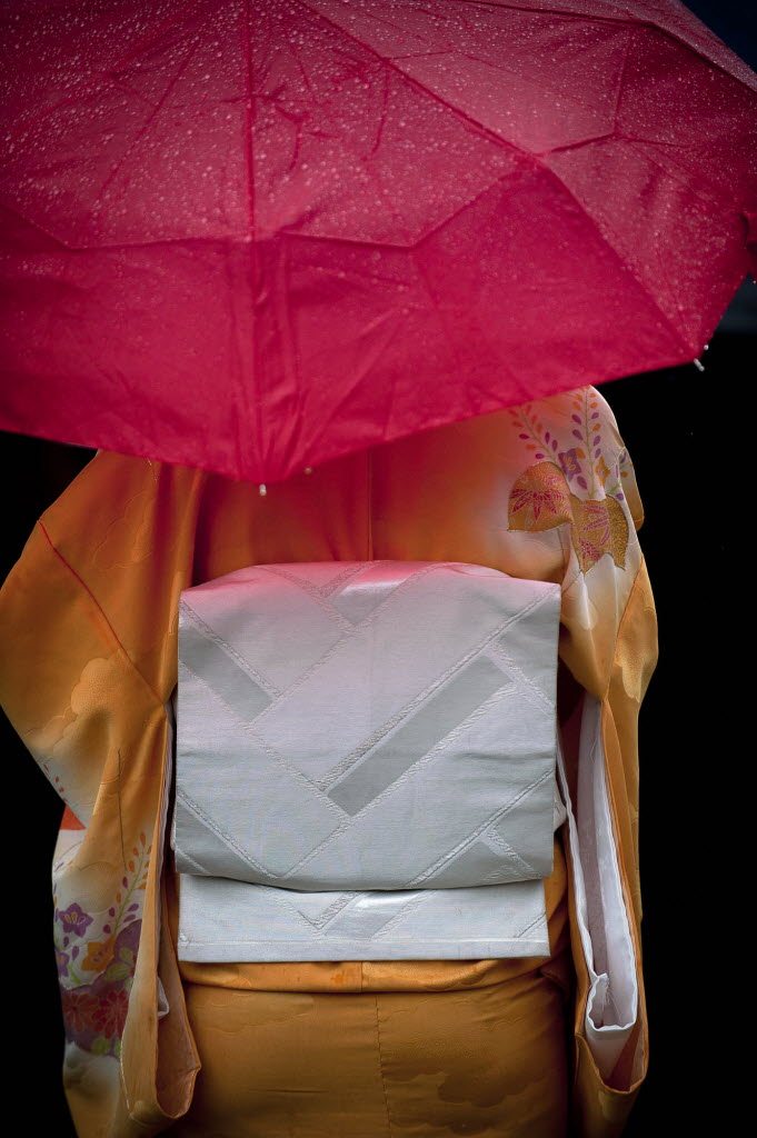 Clark College alumni Michelle Sohm, 21, of Vancouver, attempts to keep her kimono dry while attending the Sakura Festival and dedication of the Royce Pollard Japanese Friendship Garden at Clark on Thursday April 19, 2012.