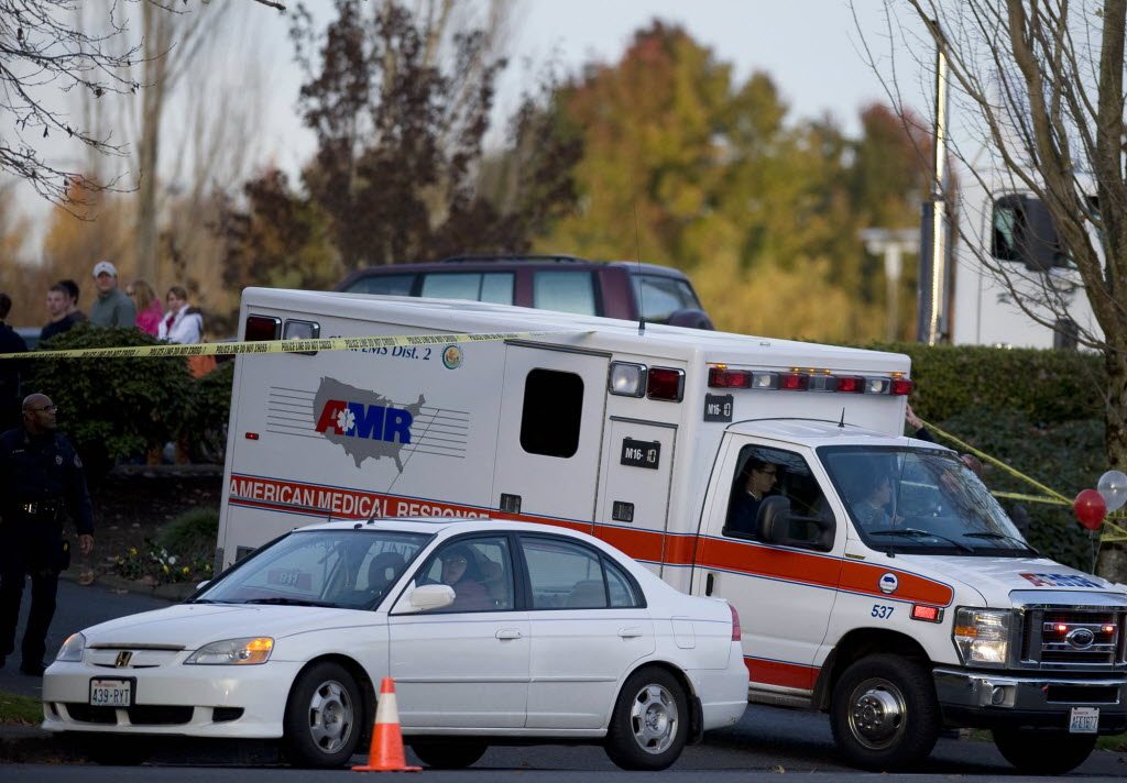 An American Medical Response ambulance leaves the scene after a bank robbery suspect was shot by police while trying to flee near the Vancouver Mall on Dec. 1.