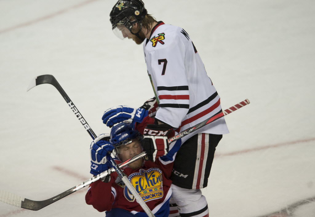 Winterhawks Joe Morrow (7) crashes into an Oil Kings player in the second period of game 6 at the Rose Garden on Saturday.