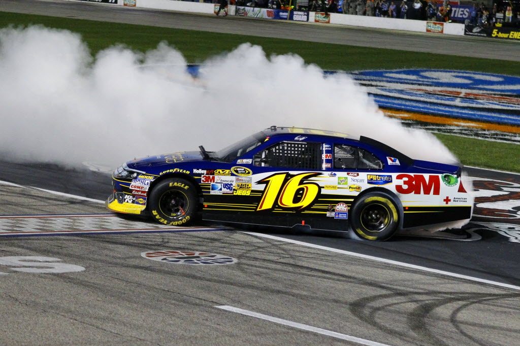 Greg Biffle (16) does a burnout as he celebrates his win Saturday at Texas Motor Speedway.