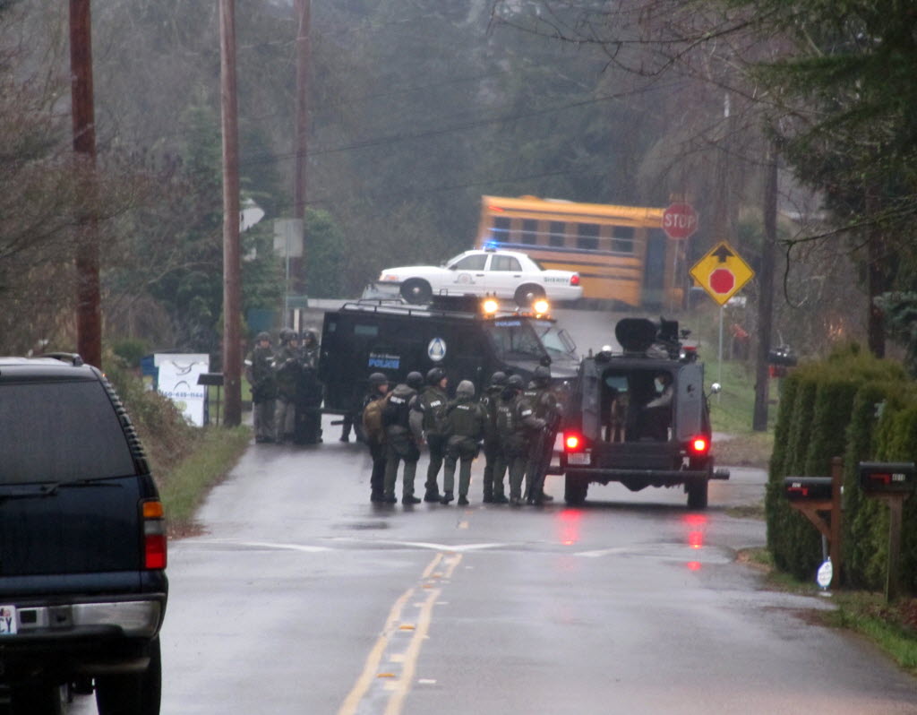Regional SWAT team members gather near a home on Northeast 40th Avenue in Vancouver Thursday.